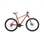 Rotes Mountainbike mit blauem Streifen auf dem Rahmen, schwarzem Sattel und Lenker. Das Fahrrad hat Scheibenbremsen, schwarze Reifen und eine Vorderradgabel mit Federung und ist für das Radfahren im Gelände konzipiert.